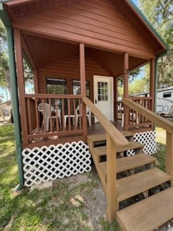 Rustic cabin entrance with wooden stairs