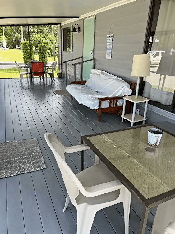 Outdoor porch with chairs and sofa