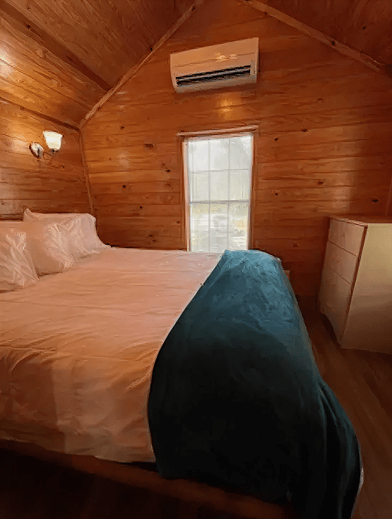 Rustic bedroom featuring wooden walls