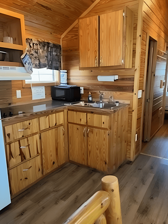 Compact kitchen with wooden cabinets and floor