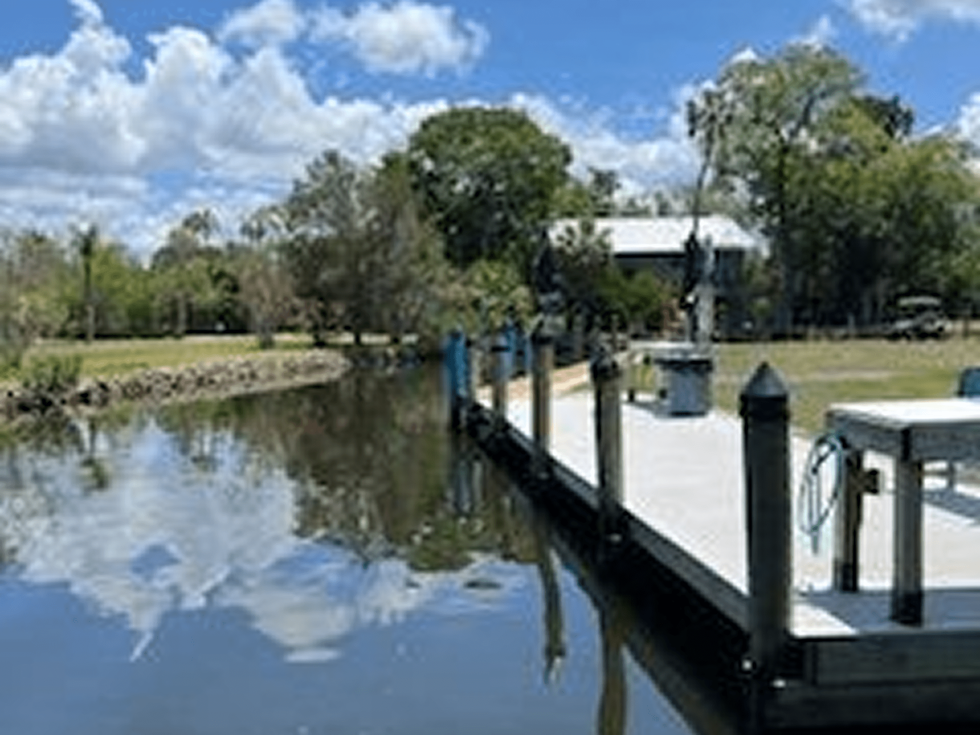Peaceful riverside scene with blue sky