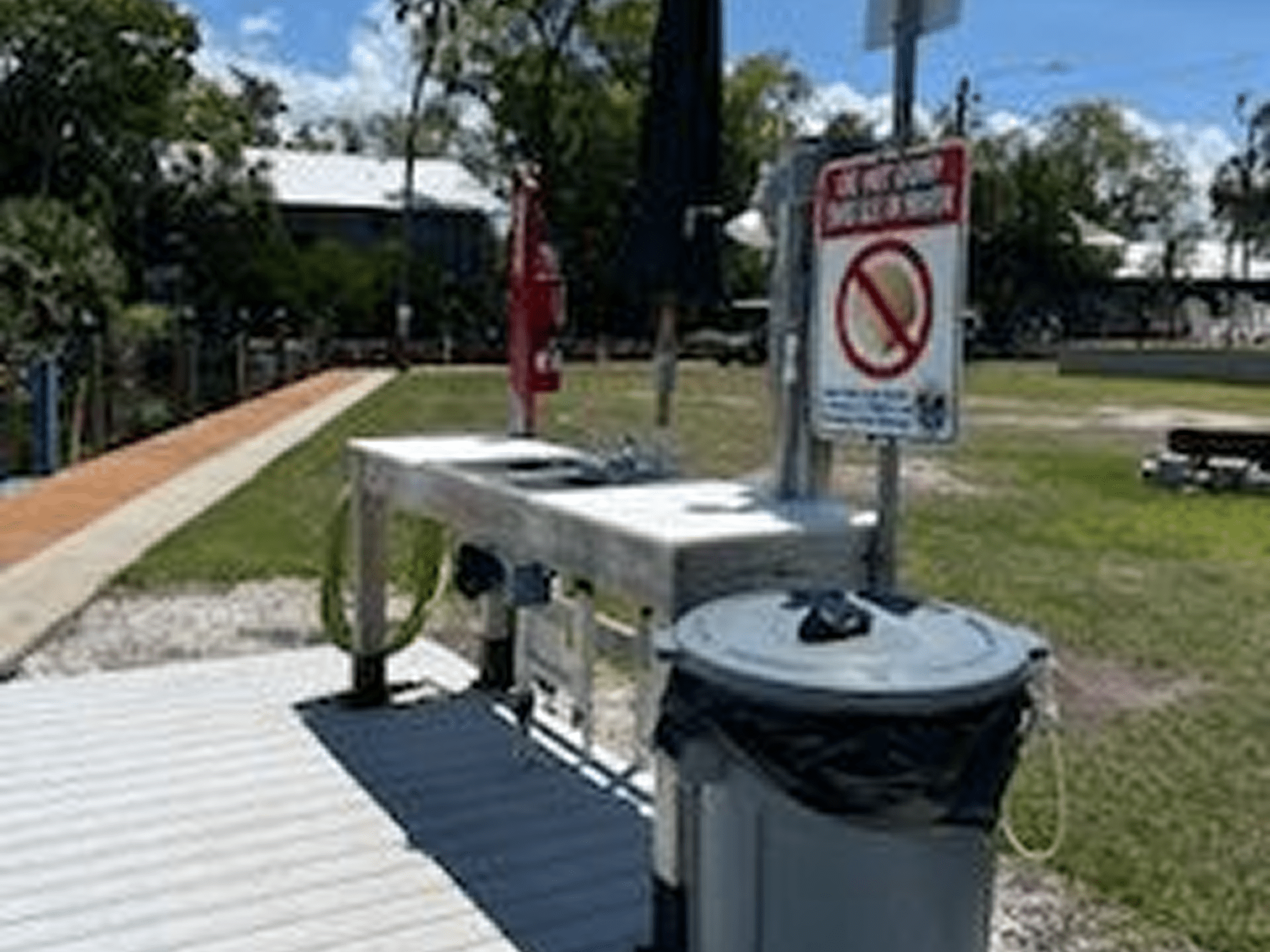 Outdoor cleaning station with a no-fishing sign.